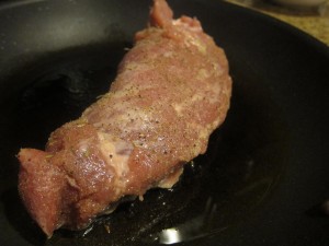 Searing pork tenderloin.